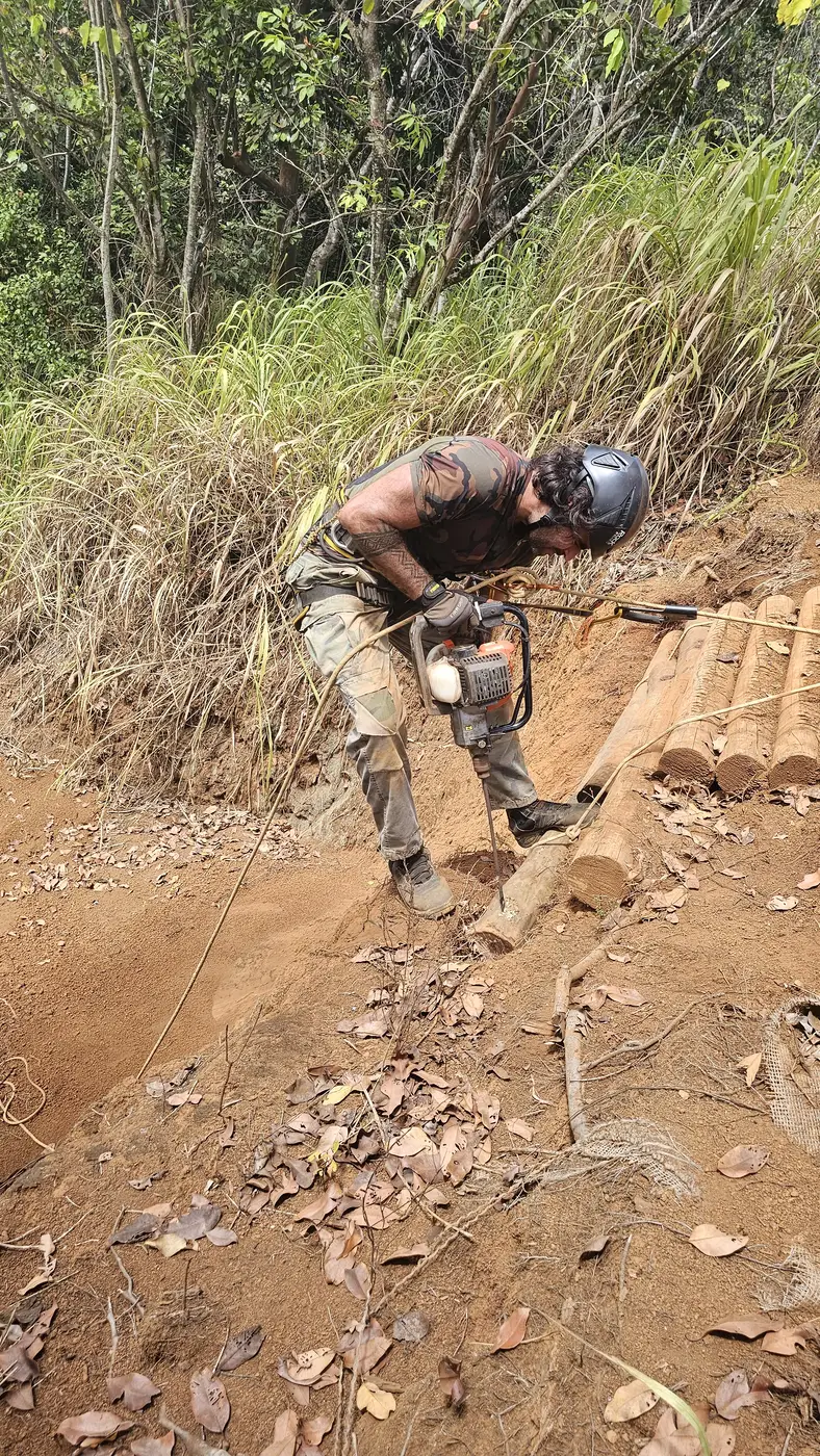Cutting crib steps into a steep bank with a chainsaw
