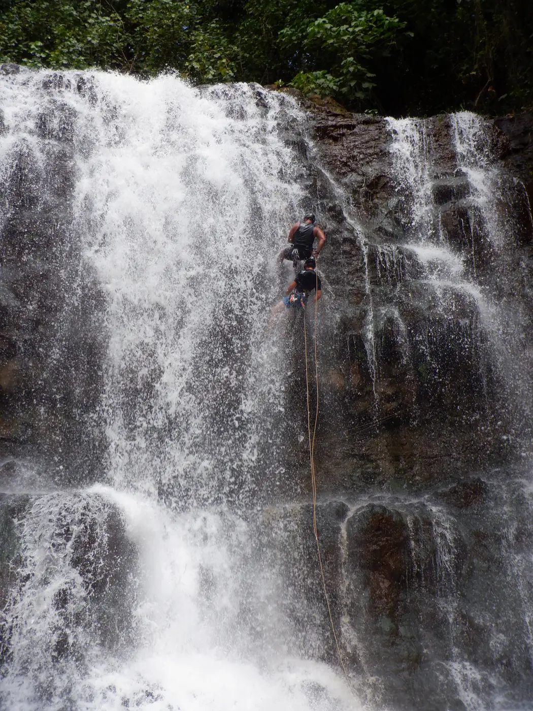 Rappeller on the face of a tall waterfall