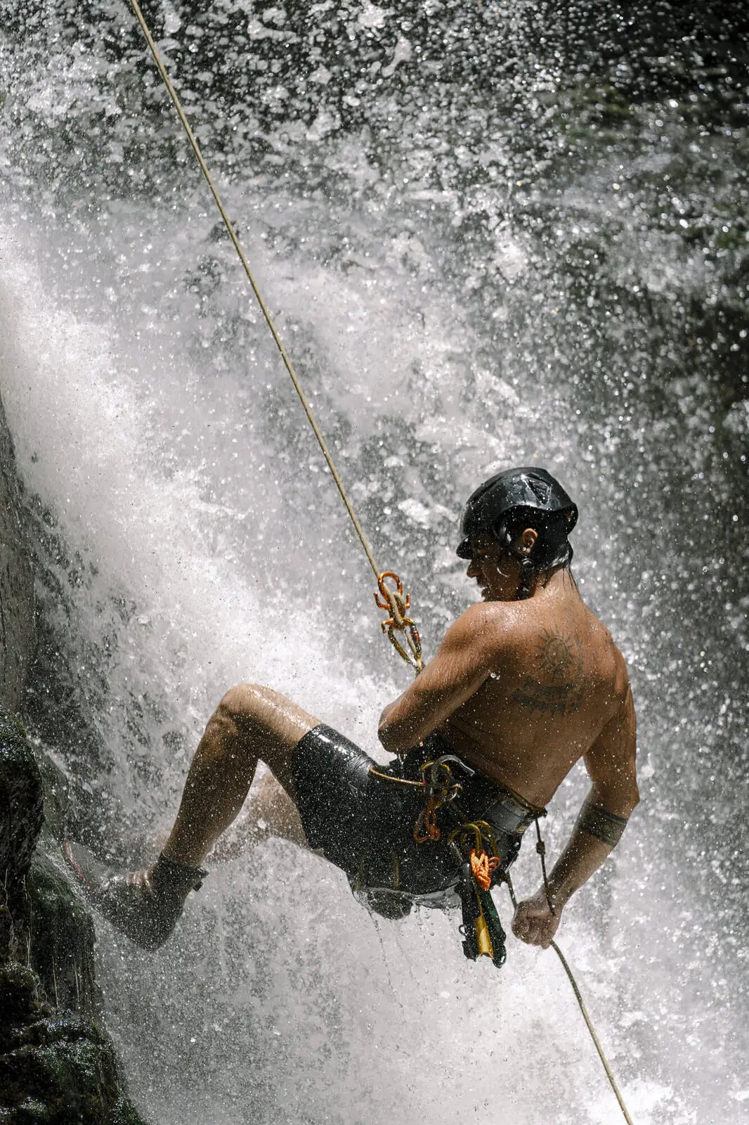 Rappelling down the face of a waterfall