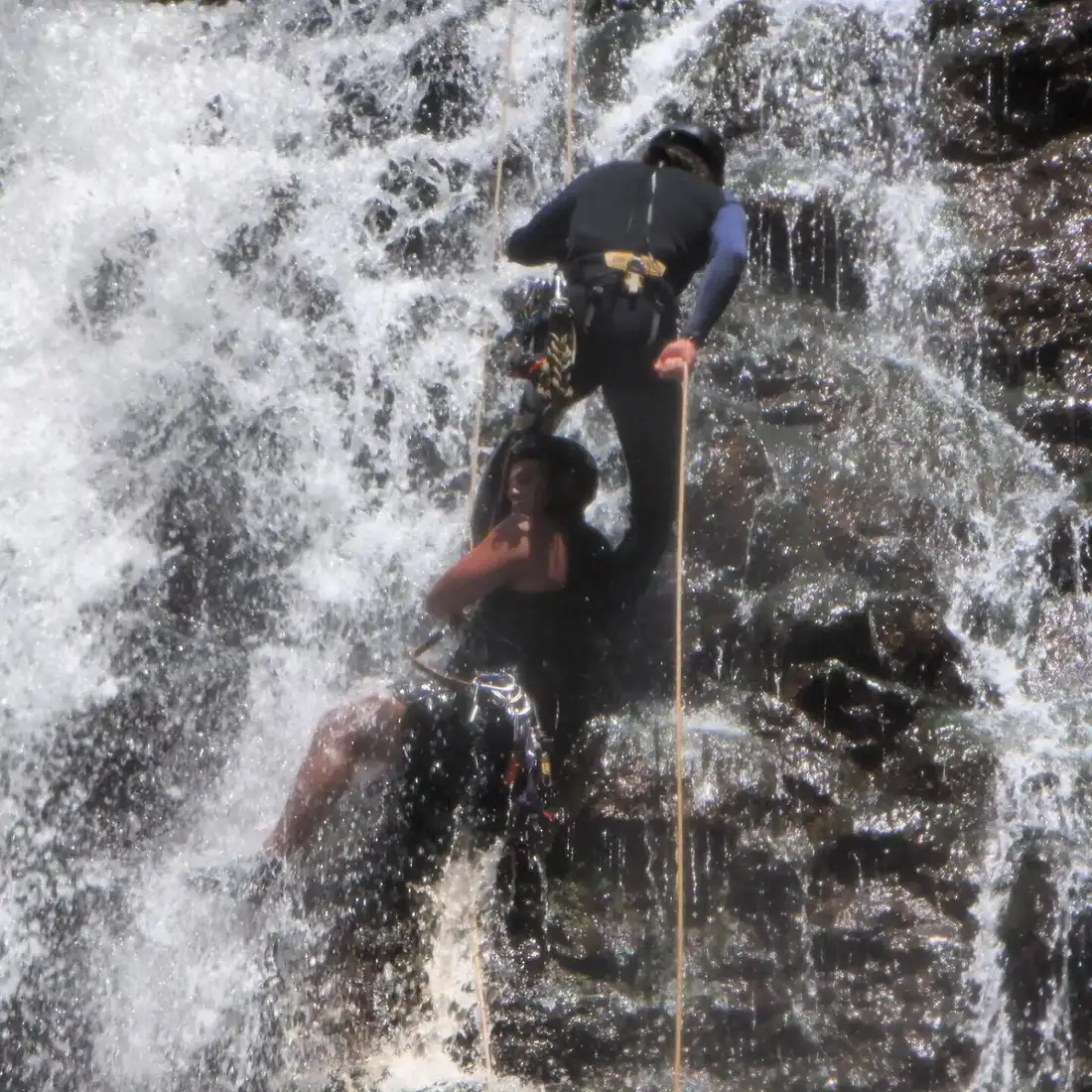 Rappelling through a waterfall